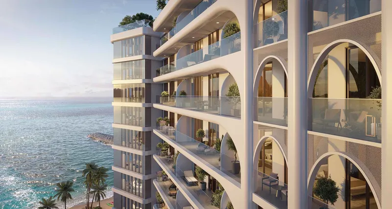 Render of the arched balconies and curved corners of a Seef Residences tower above the Gulf