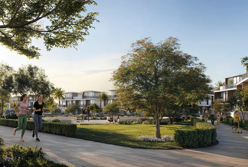 Tree-lined neighbourhood park with villas behind at Selvara 4