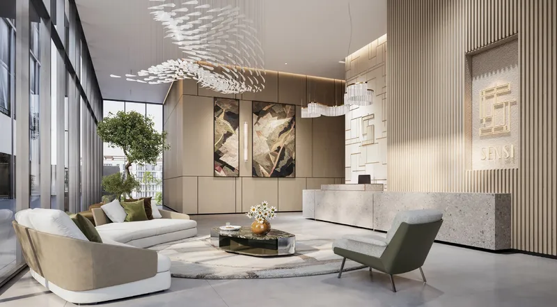 Residential lobby at Sensi with a reception desk and lounge seating (developer render)