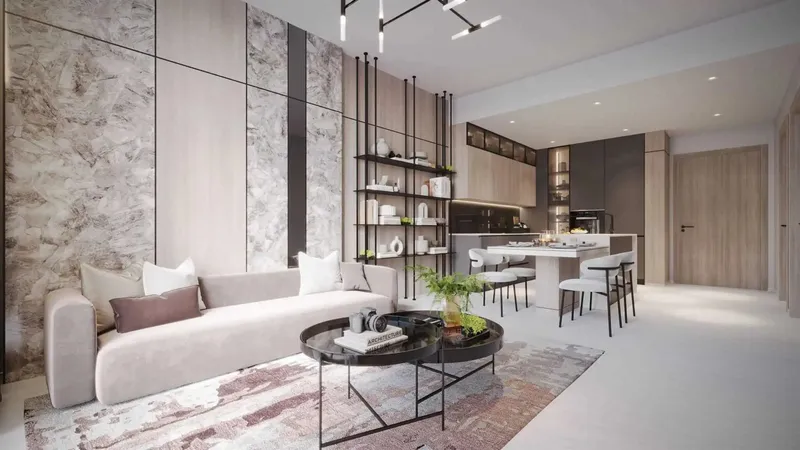 Furnished living and dining room with a pale sofa, shelving and an open kitchen in a Serene Gardens II apartment