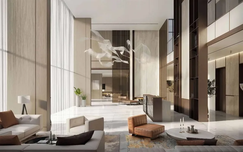 Double-height lobby with a suspended sculpture, a reception desk and lounge seating at Serene Gardens II