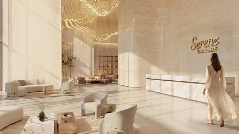Double-height lobby with reception desk at Serenz by Danube