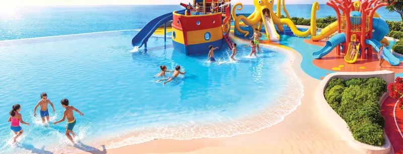 Render of the children’s water play area with slides beside the lagoon