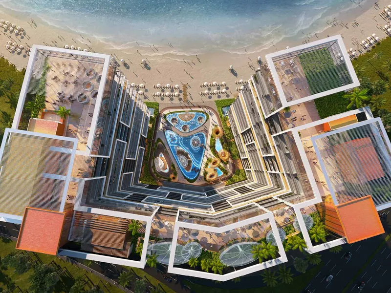 Top-down aerial render of Shoreline by DAMAC showing the central pool deck opening onto the beach