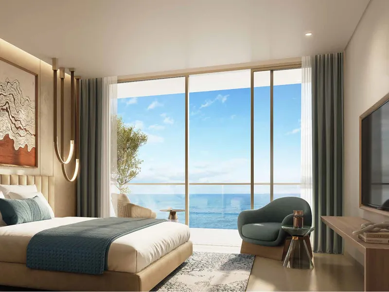 Bedroom at Shoreline by DAMAC with full-height glazing facing the sea