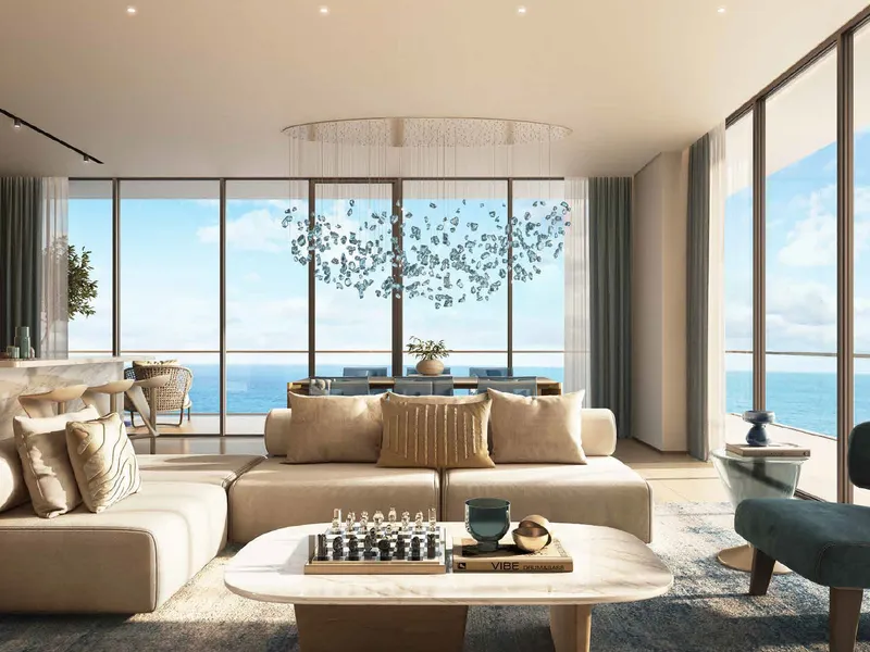 Living room at Shoreline by DAMAC with floor-to-ceiling windows and a sea view
