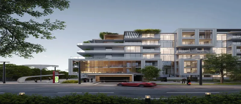 Sila building seen from the road at dusk, with planted roof terraces (developer render)