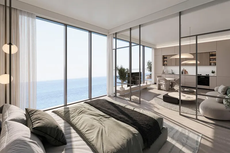 Bedroom with floor-to-ceiling windows and sea view in a Skai apartment