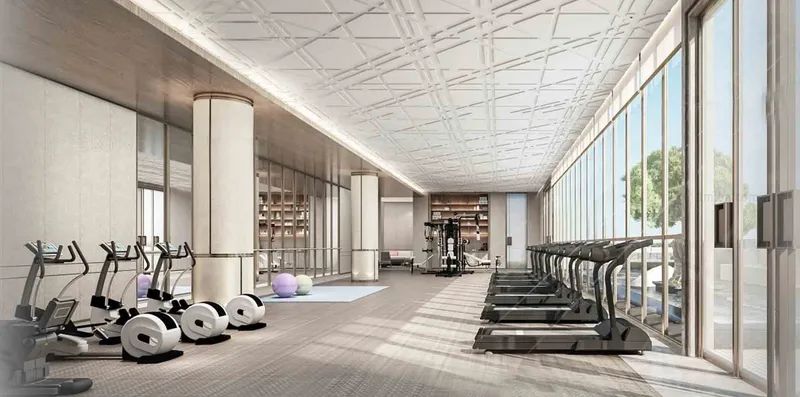 Render of the Sky Suites gym with treadmills and cross trainers beside full-height windows