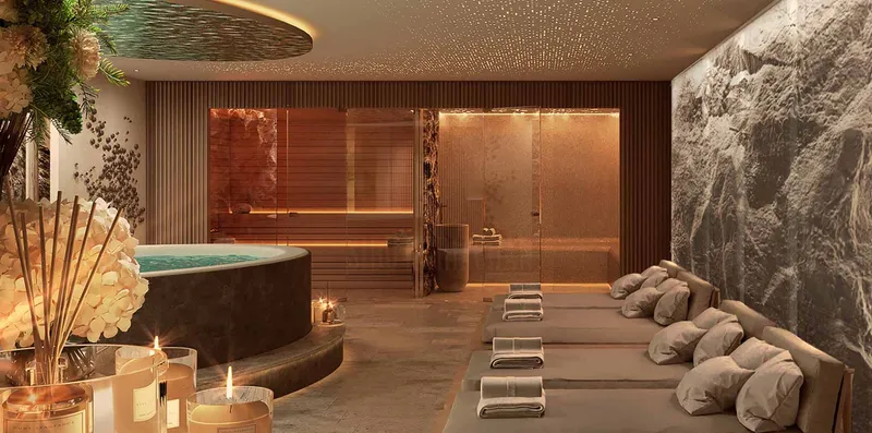 Render of the Sky Suites spa with a jacuzzi, loungers and a stone feature wall