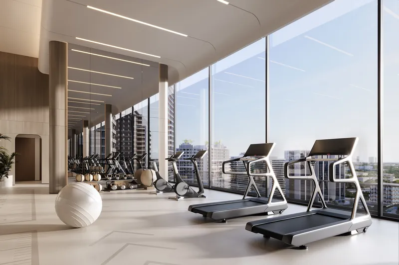 Indoor gym with treadmills and full-height windows at Skyhills Astra