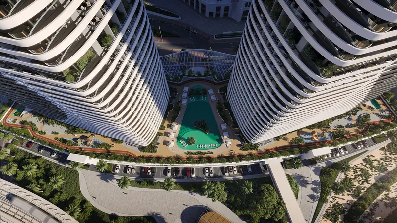Aerial view down between the two curved Skyhills Astra towers to the podium pool and gardens