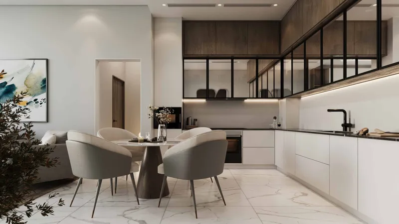 Fitted white kitchen with a round dining table in a Skyhills Residences 3 apartment