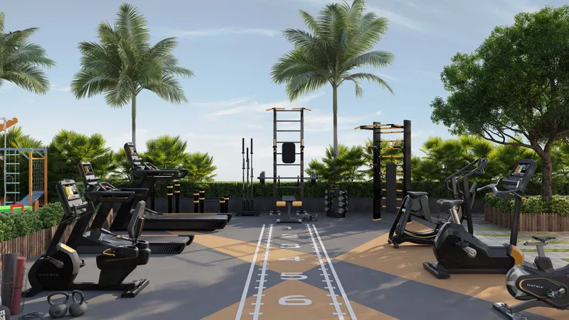 Outdoor gym with treadmills, bikes and a training rig among palms at Skyhills Residences 3