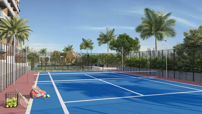 Blue tennis court surrounded by palms at Skyhills Residences 3