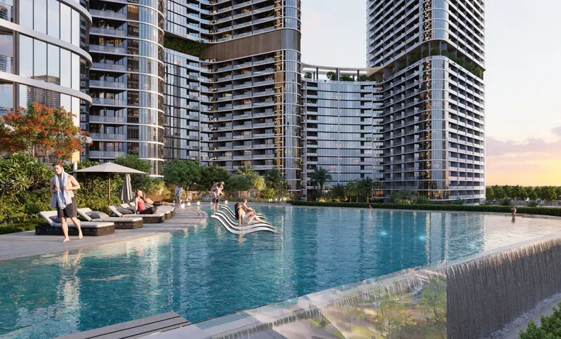 Infinity pool with sun loungers at Skyvue, facing the towers of Sobha Hartland II