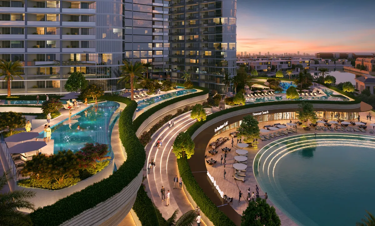 Pools, terraced gardens and the lagoon edge at the foot of the Skyvue towers at dusk