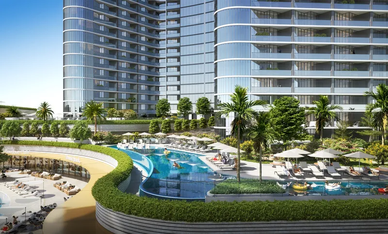 Leisure pool, sun deck and sandy lagoon edge below the Skyvue towers