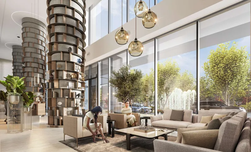 Double-height Sobha Orbis lobby lounge with sculpted shelving columns and garden views