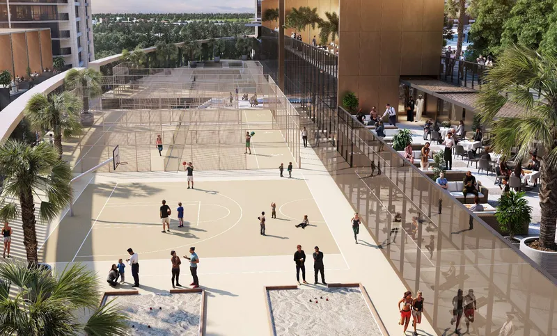Outdoor sports courts and pétanque pitches beside a seating terrace at Sobha Orbis