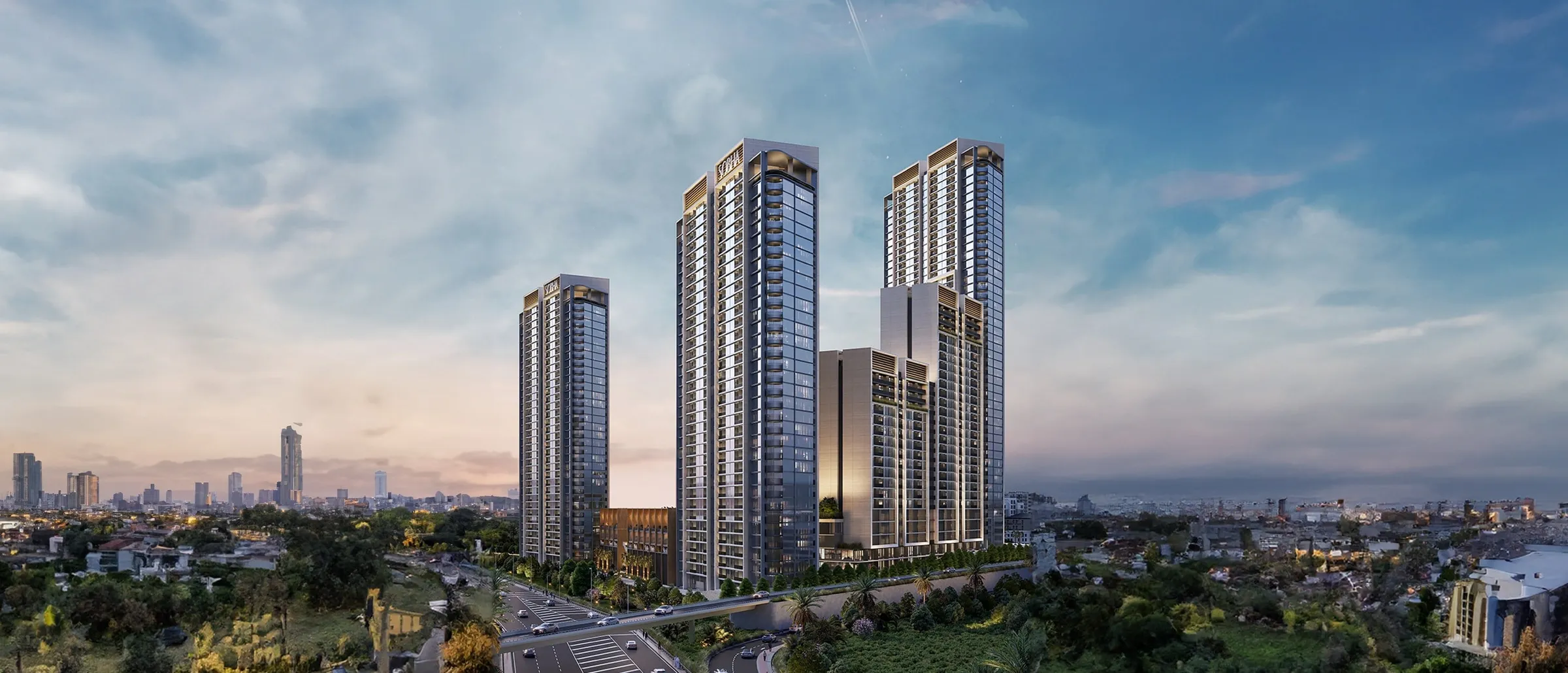 Sobha Orbis towers rising above landscaped gardens and a road interchange in Motor City, Dubai