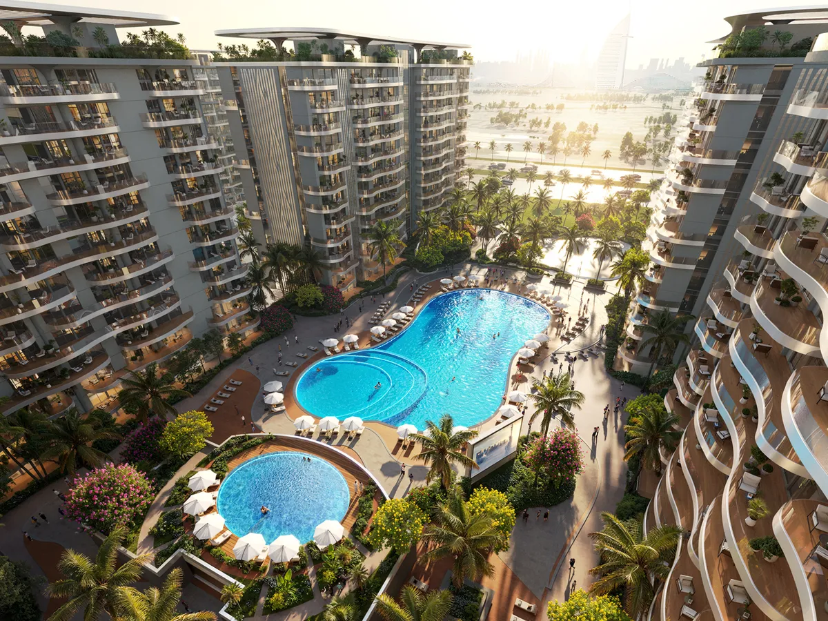 Aerial render of a pool deck with loungers and palm trees between Sorrento apartment buildings