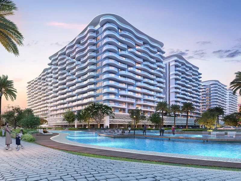 Render of Sorrento's curved white apartment buildings behind a lagoon pool at DAMAC Lagoons