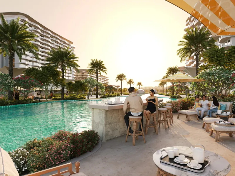 Pool bar with stools and lounge seating beside a lagoon pool at Sorrento