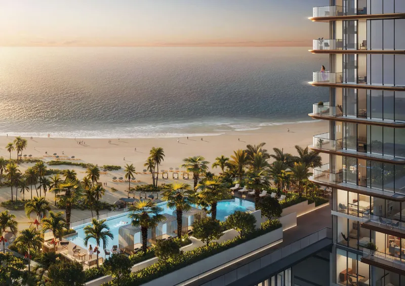 Render of the pool deck and palm gardens at Soto Grande, with the beach beyond