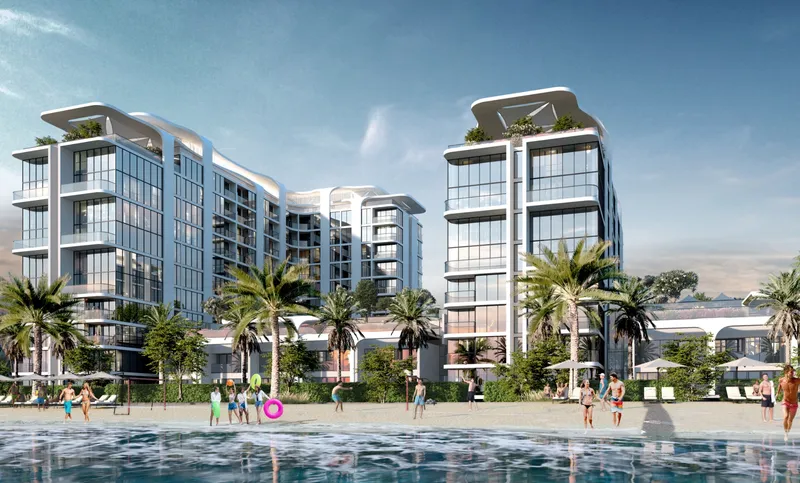 Starline Beach Residences seen from the water, with people on the beach in front of the buildings