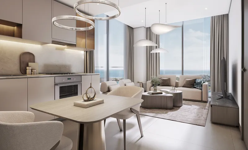Open living, dining and kitchen area of an apartment at Starline Beach Residences with full-height windows to the sea
