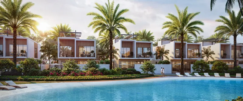 Render of Sukoon villas lining the crystal lagoon, with sun loungers and palm trees along the water
