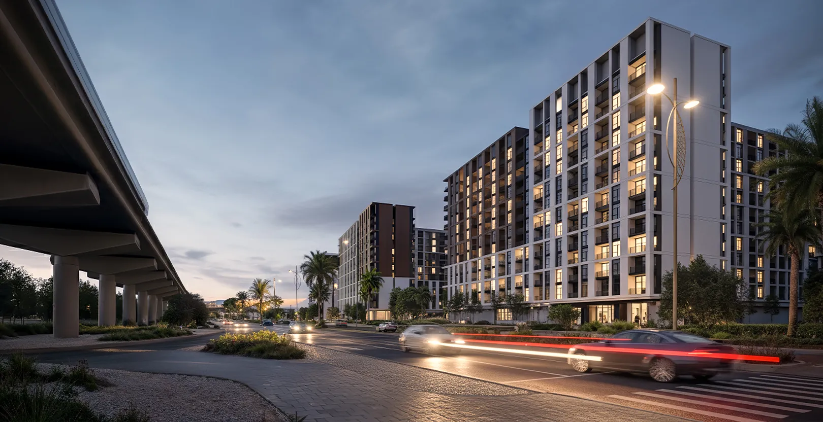 Render of the mid-rise Terra Gardens apartment buildings at dusk seen from the road