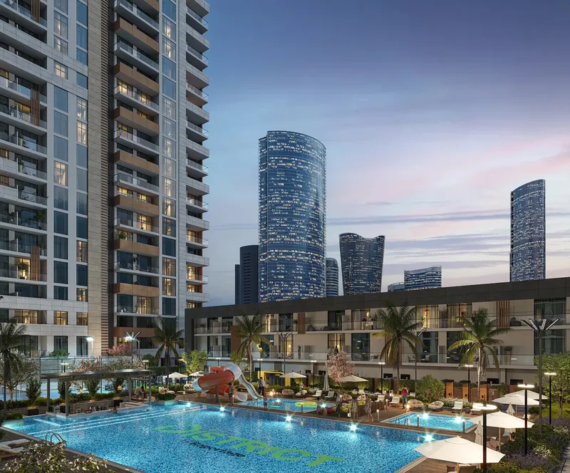 Podium swimming pool and townhouse terrace at The District at dusk, with Al Reem Island towers beyond (developer render)