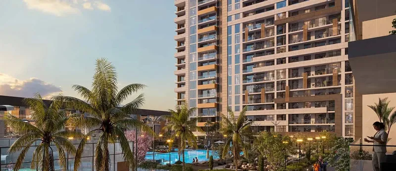 Residential tower at The District rising over the podium gardens and pool at sunset (developer render)