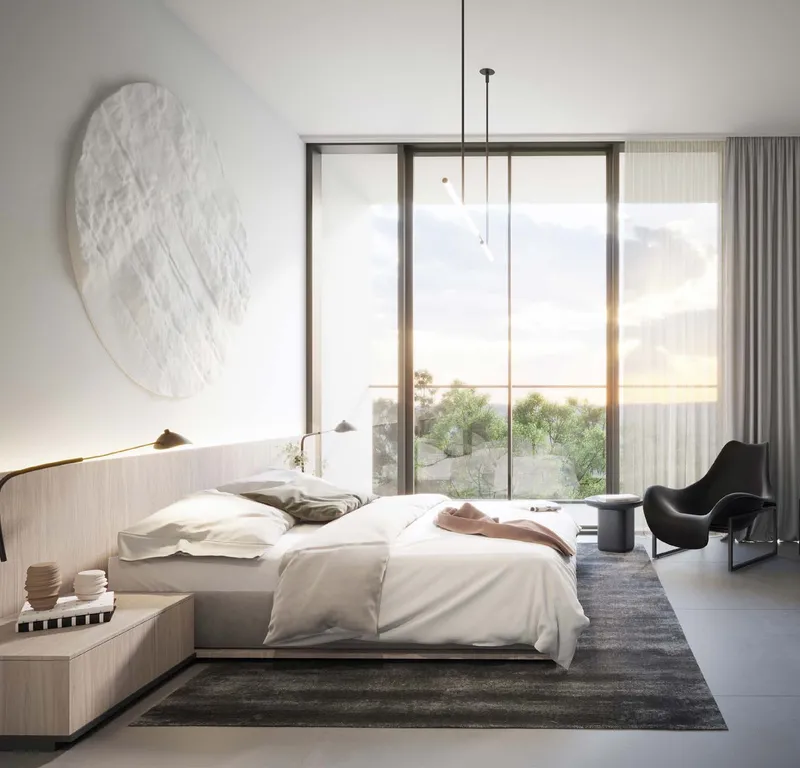 Render of an apartment bedroom at The Gate, Aljada, with a double bed, armchair and full-height window