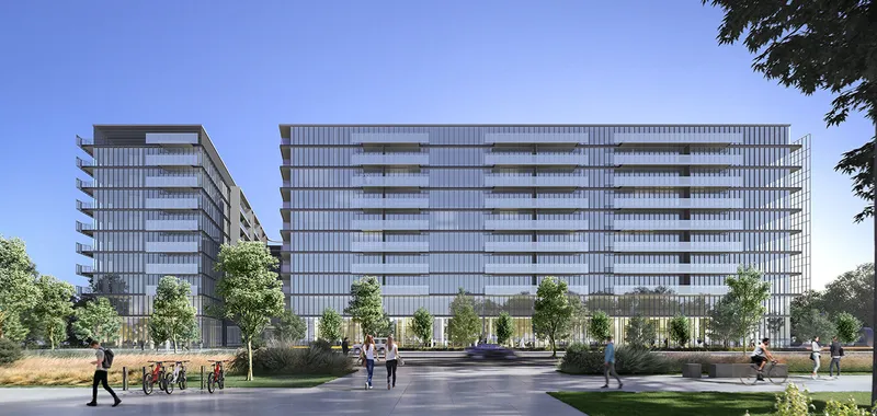 Render of two The Gate apartment buildings at Aljada seen across a park with trees and a paved path