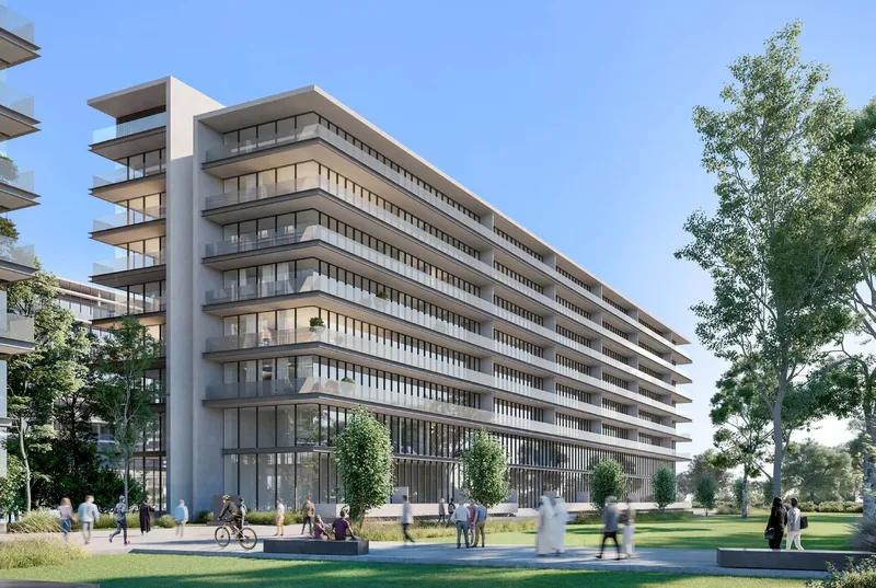 Render of a The Gate apartment building at Aljada with long horizontal balconies, seen from a landscaped park with people walking and cycling