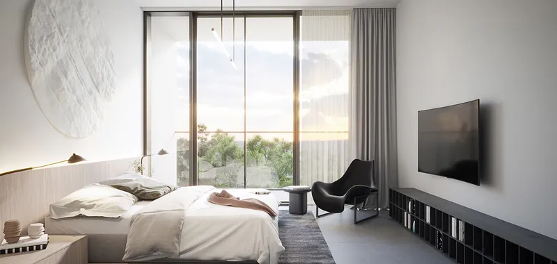 Render of an apartment bedroom at The Gate, Aljada, with a double bed, lounge chair and full-height glass doors to a balcony