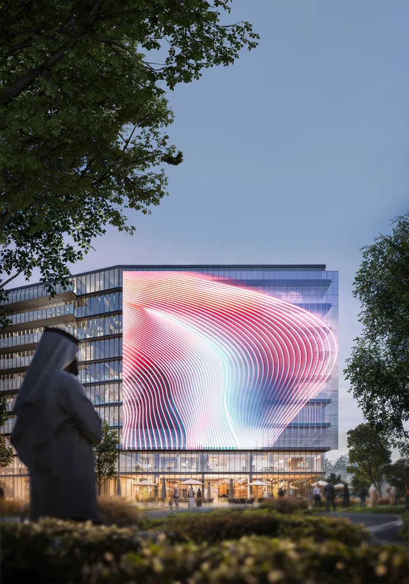 Evening render of the illuminated corner screen of The Gate 6 at Aljada seen between trees from across the street