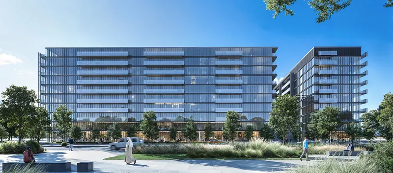 Daytime render of the glass street facade of The Gate 6 at Aljada with balconies on every floor and landscaped paving in front