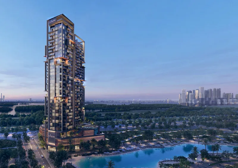 Aerial render of The Highgrove tower by Ellington Properties beside the crystal lagoon in Mohammed Bin Rashid City at dusk
