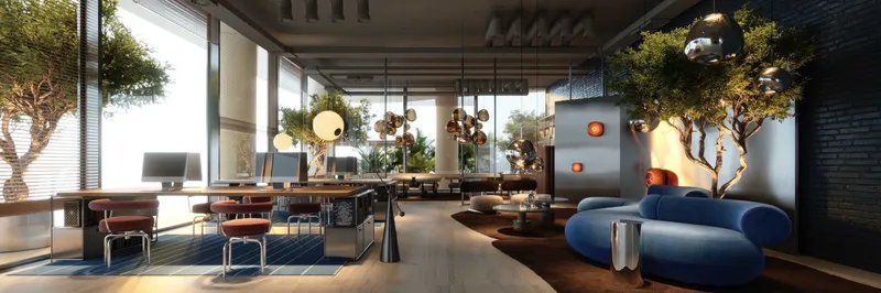 Co-working lounge with desks, lounge seating and indoor trees at The WOW Tower