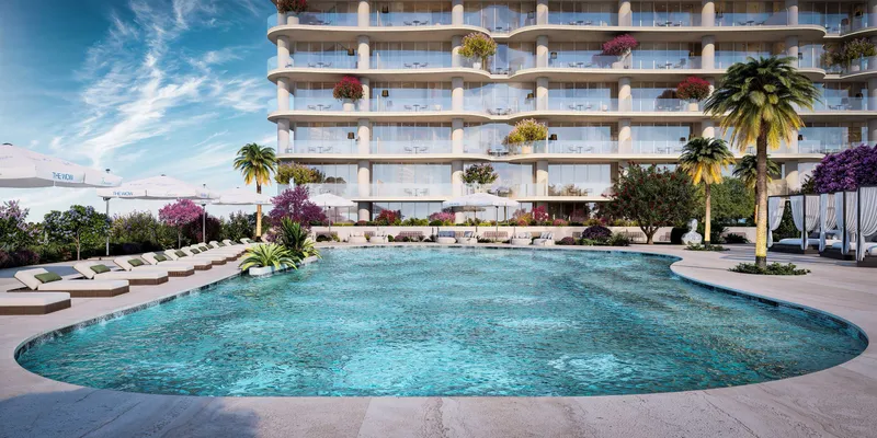 Resort-style pool with sunbeds and cabanas on the podium park of The WOW Tower