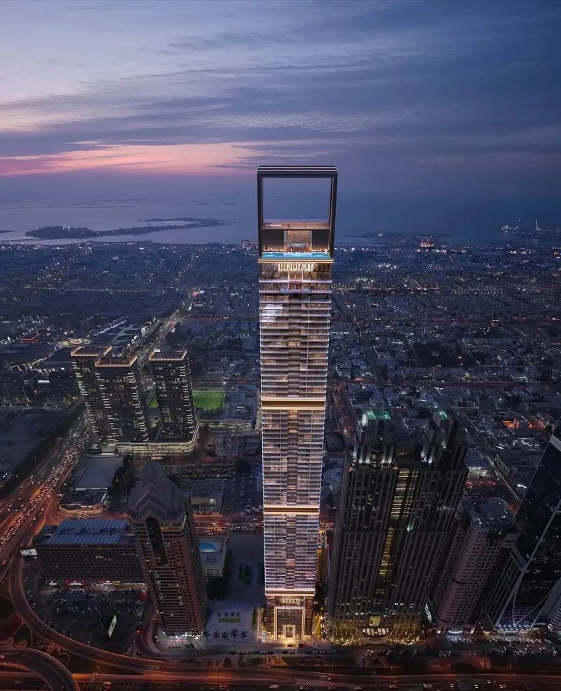 Aerial night view of Trump International Hotel & Tower Dubai with the coast in the distance