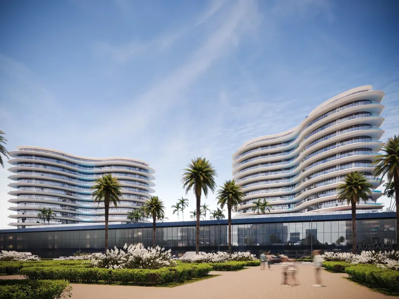 Render of the two curved towers of Trussardi Residences Phase II above a landscaped podium in Al Furjan