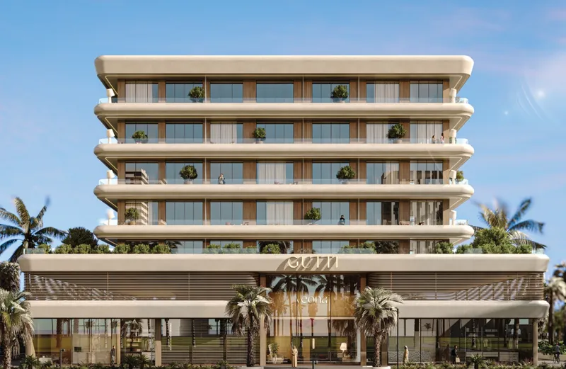 Front elevation of Veona by Gutti in Dubailand Residence Complex, with curved terraces above a retail podium