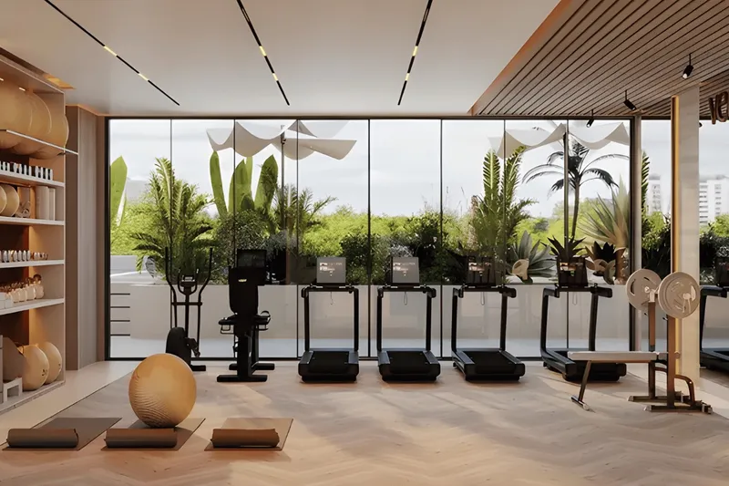Indoor gym at Veona by Gutti with treadmills facing a planted terrace