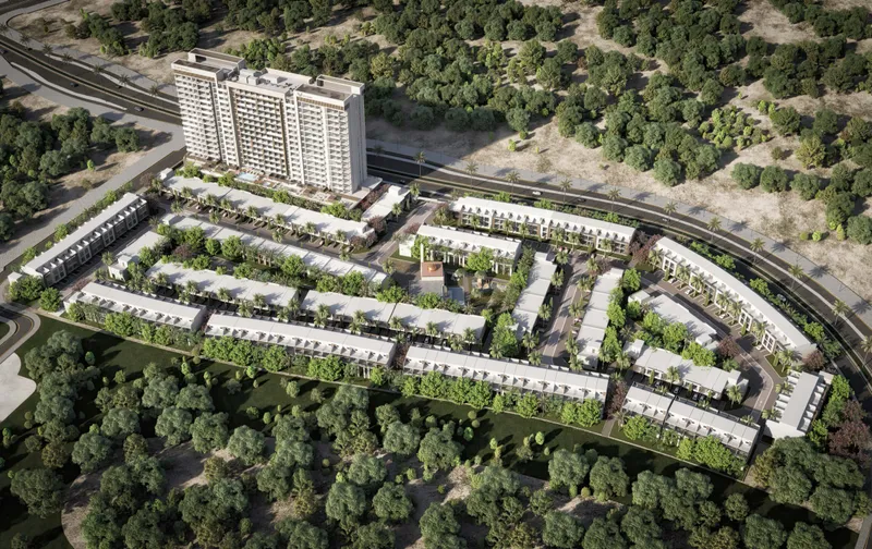 Aerial view of Verdana VII in Dubai Investments Park: an apartment building beside rows of townhouses among trees (developer render)