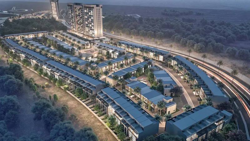 Verdana VII townhouses and apartment tower seen from above at dusk (developer render)